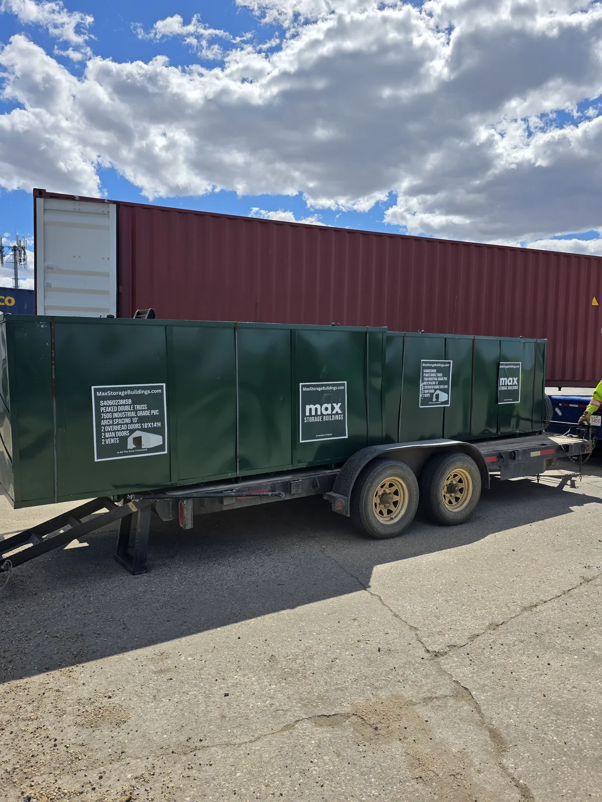 Green building-component crates loaded on a trailer
