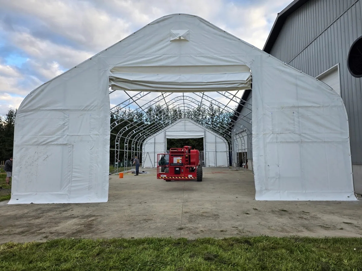 White endwall and doorway with open roof framing visible behind