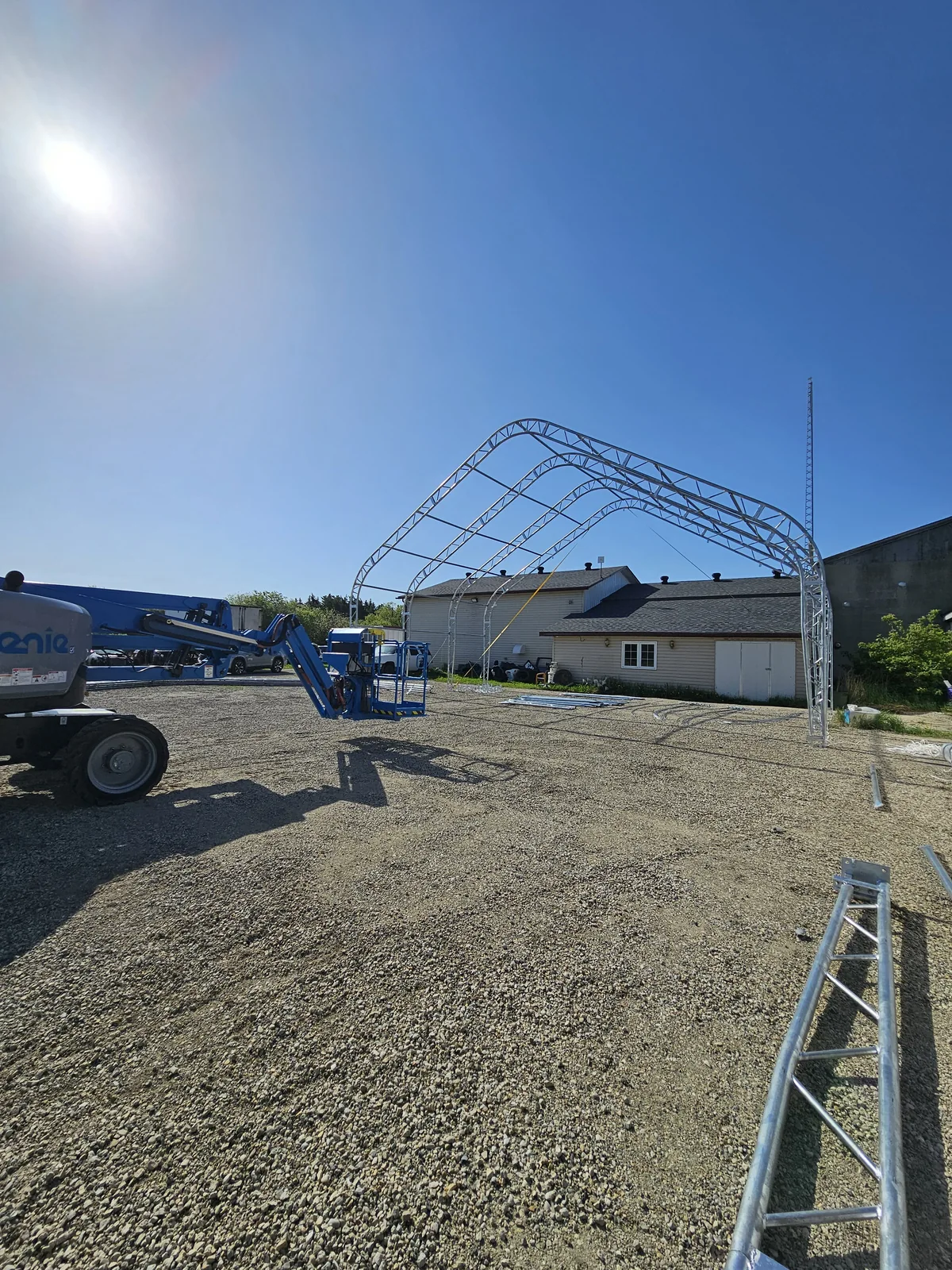 First steel arches standing beside an existing yard building